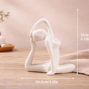 May include: A set of three ceramic mugs with a speckled, matte finish. The mugs are in shades of cream, light gray, and dark gray. Each mug has a simple, minimalist design, perfect for coffee or tea.
