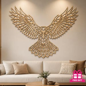 May include: A large, geometric wooden eagle wall art piece with outstretched wings. The eagle is made of light brown wood and is mounted on a neutral-colored wall. The wings and body are intricately cut with a geometric pattern.