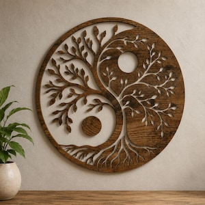May include: A circular wall art piece made of dark brown wood featuring a laser-cut design of a tree with branches and roots forming a yin and yang symbol. The design includes two solid circular cutouts representing the dots of the symbol.