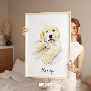 May include: Watercolor portrait of a Golden Retriever puppy named Honey, wearing a blue collar. The artwork is in a wooden frame. The dog is lying down, with a happy expression. The portrait is signed by Firum Portraits.