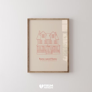 May include: Framed print featuring a red line drawing of a house with the words "home sweet home" and address details. The artwork is set against a beige background and framed in a light brown wooden frame.