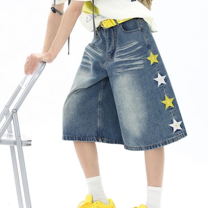 Star Embroidered Shorts | Wide Leg Denim Jorts | Daily Wear | Y2K Streetwear Style

Blue wide leg denim shorts with star embroidery patches styled with bright sneakers in Y2K streetwear outfit.