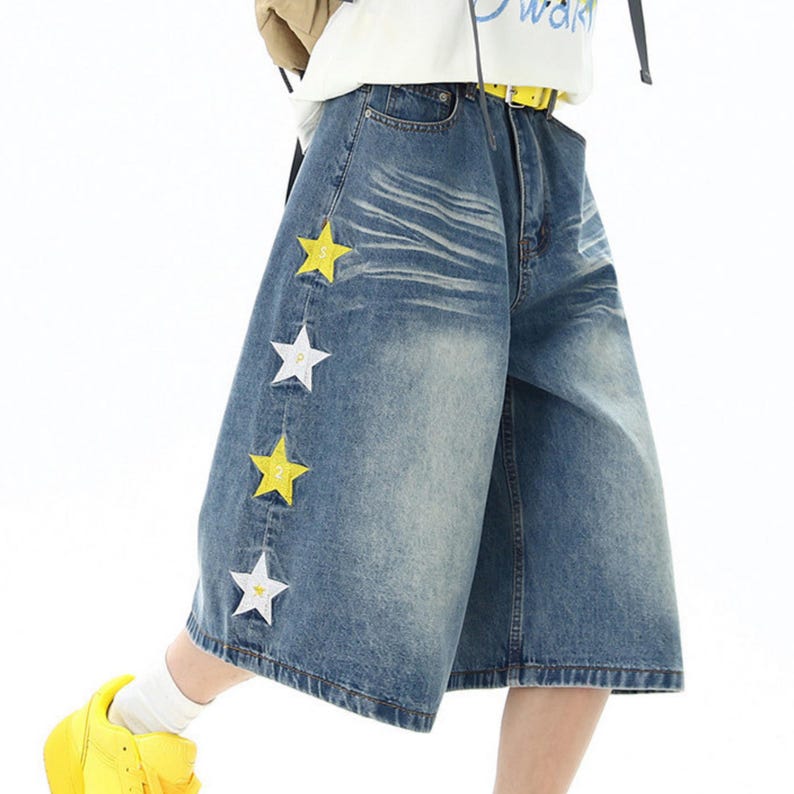 Star Embroidered Shorts | Wide Leg Denim Jorts | Daily Wear | Y2K Streetwear Style

Blue wide leg denim shorts with star embroidery patches styled with bright sneakers in Y2K streetwear outfit.