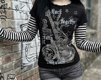 May include: A black short-sleeved t-shirt with long black and white striped sleeves. The front features a large silver graphic of an electric guitar, swirling floral patterns, stars, and the text Rock Together, Crazy, and Broken in a gothic font.