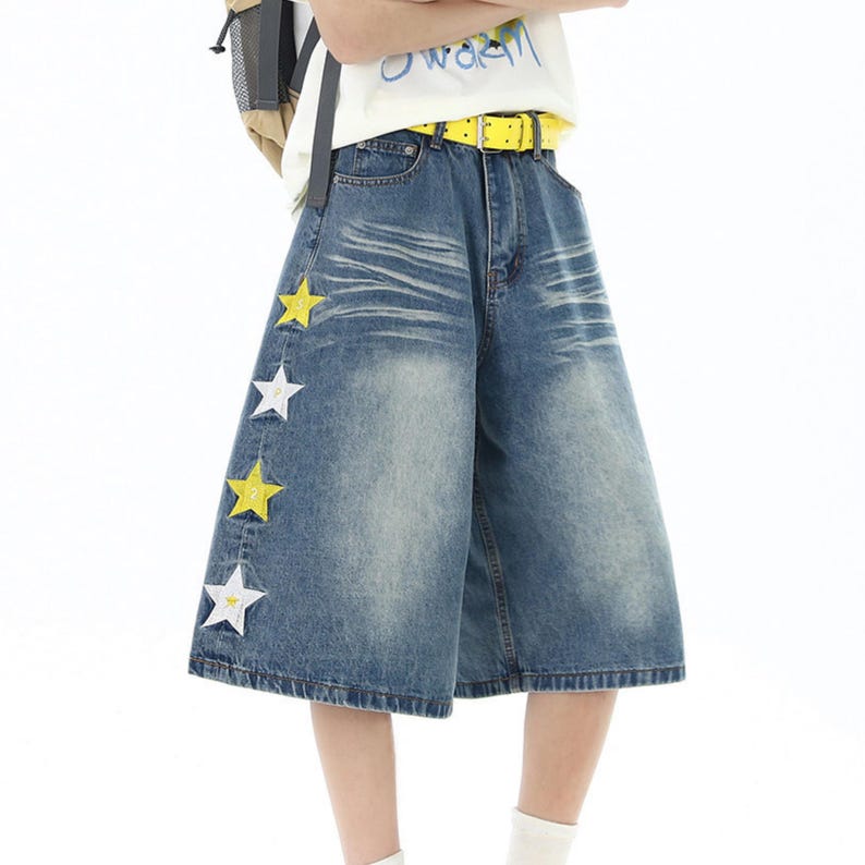 Star Embroidered Shorts | Wide Leg Denim Jorts | Daily Wear | Y2K Streetwear Style

Blue wide leg denim shorts with star embroidery patches styled with bright sneakers in Y2K streetwear outfit.