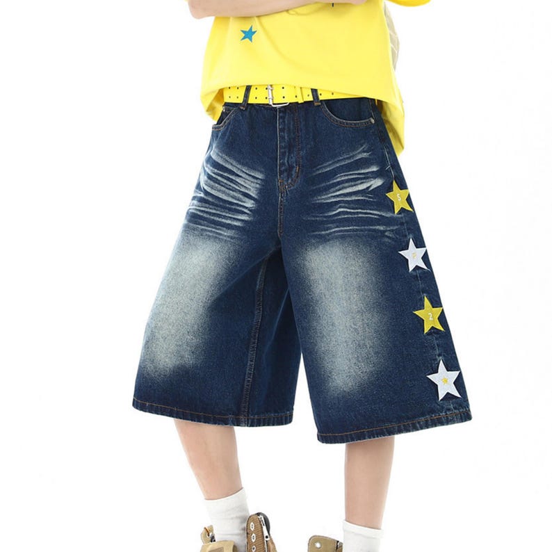 Star Embroidered Shorts | Wide Leg Denim Jorts | Daily Wear | Y2K Streetwear Style

Blue wide leg denim shorts with star embroidery patches styled with bright sneakers in Y2K streetwear outfit.