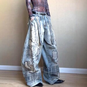 Washed Baggy Denim Jeans | Wide Leg Graphic Pants | Retro Y2K Streetwear 

Washed baggy wide leg denim jeans with graphic print and distressed detailing designed for women streetwear styling and relaxed outfits.