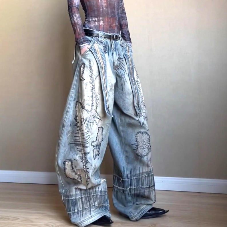 Washed Baggy Denim Jeans | Wide Leg Graphic Pants | Retro Y2K Streetwear 

Washed baggy wide leg denim jeans with graphic print and distressed detailing designed for women streetwear styling and relaxed outfits.