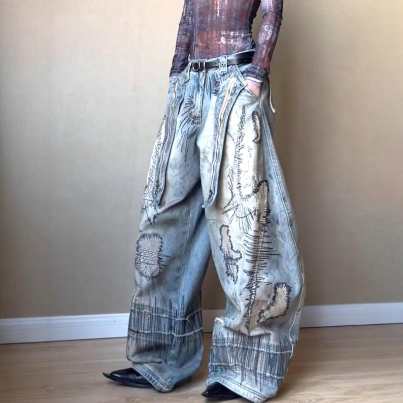 Washed Baggy Denim Jeans | Wide Leg Graphic Pants | Retro Y2K Streetwear 

Washed baggy wide leg denim jeans with graphic print and distressed detailing designed for women streetwear styling and relaxed outfits.