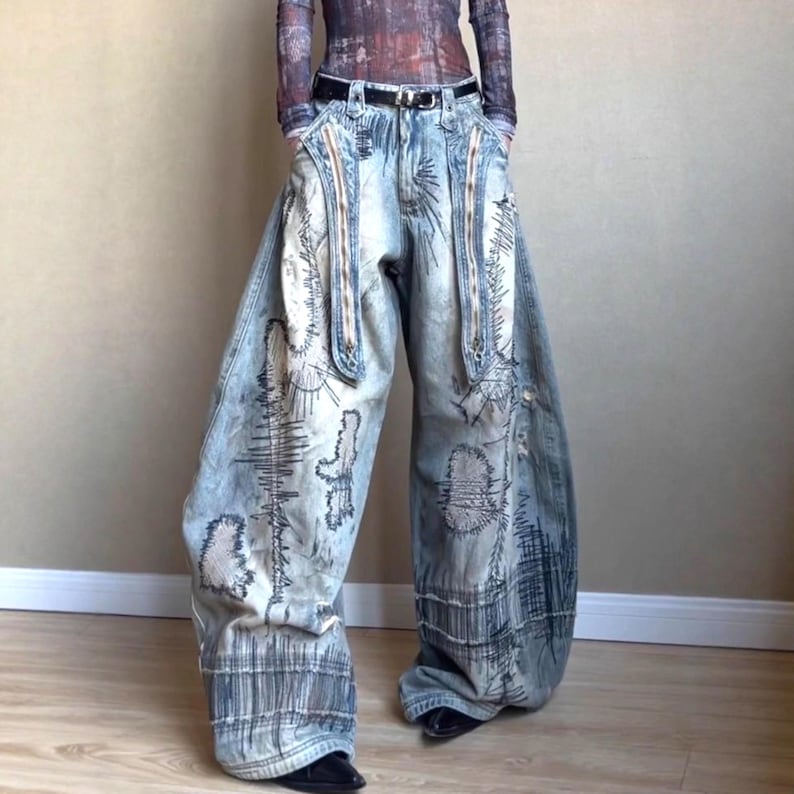 Washed Baggy Denim Jeans | Wide Leg Graphic Pants | Retro Y2K Streetwear 

Washed baggy wide leg denim jeans with graphic print and distressed detailing designed for women streetwear styling and relaxed outfits.