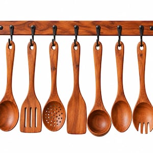 May include: A set of seven wooden kitchen utensils hanging from black metal hooks on a horizontal wooden rack. The collection includes a solid spoon, a slotted turner, a skimmer, a flat spatula, a ladle, a round spoon, and a salad fork.