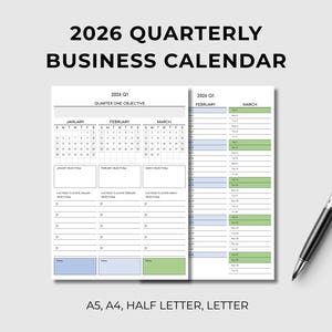 May include: A business calendar for 2026, featuring a quarterly layout with January, February, and March calendars. The calendar includes space for objectives and actions. A black and silver pen rests beside the calendar. The text "2026 Quarterly Business Calendar" is at the top.