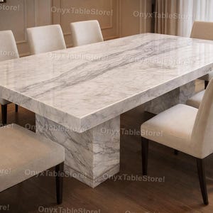 May include: A set of three ceramic mugs with a speckled, matte finish. The mugs are in shades of cream, light gray, and dark gray. Each mug has a simple, minimalist design, perfect for coffee or tea.