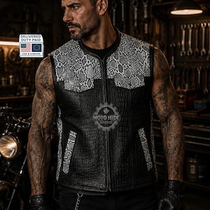 May include: Black leather vest with a snakeskin pattern on the shoulders and pockets. The vest has a zipper closure and is worn with black gloves and pants. The image includes the text "MOTO HIDE CUSTOMS".