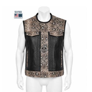 May include: A black leather vest with a snakeskin pattern on the shoulders, centre, and pockets. The vest has a round collar and two front pockets. The brand name "MOTO HIDE" is visible on the front. The vest is displayed on a mannequin.
