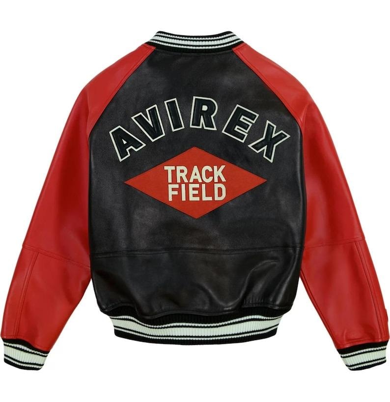 Op de afbeelding: Een zwart en rode leren jas met het woord "AVIREX" over de rug, boven een rode ruit met de woorden "TRACK FIELD". De jas heeft rode mouwen, een zwarte body en een gestreepte kraag en manchetten.