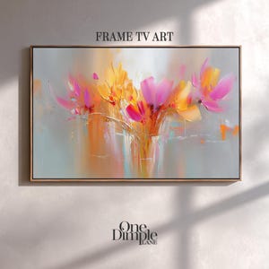 Puede incluir: Pintura floral abstracta en un marco rectangular. La obra presenta vibrantes flores rosas y amarillas con acentos naranjas y grises. Las palabras "FRAME TV ART" están en la parte superior y "One Dimple Lane" en la inferior.