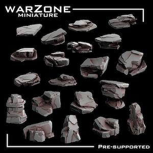 Puede incluir: Una colección de formaciones rocosas grises en miniatura, perfectas para juegos de mesa o modelismo. Las rocas varían en tamaño y forma, con una superficie detallada y texturizada. La imagen incluye el texto "Warzone Miniature" y "Pre-Supported".