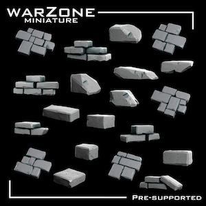 Puede incluir: Colección de piezas de terreno en miniatura grises, incluyendo bloques de piedra y formaciones rocosas, sobre un fondo negro. Los textos "WARZONE MINIATURE" y "PRE-SUPPORTED" son visibles.