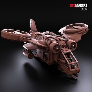 May include: A brown, unpainted miniature model of a futuristic VTOL aircraft featuring two large ducted fans on the wings, a cockpit with visible pilot figures, a multi-barrelled weapon pod, and intricate mechanical detailing across the fuselage.