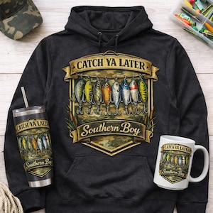 May include: A dark gray hoodie, tumbler, and mug featuring a fishing lure design. The phrase "Catch Ya Later" is above the lures, and "Southern Boy" is below. A camouflage baseball cap is also visible.