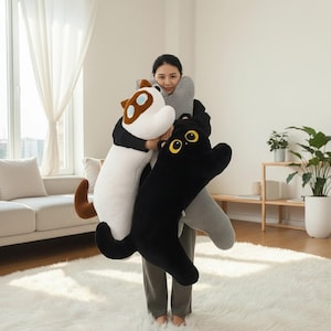 May include: A white ceramic mug with a black handle and the text "But First, Coffee" in a handwritten style. The mug is on a white surface. The mug is approximately 4 inches tall.