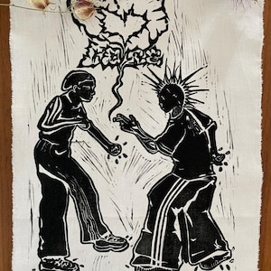 Könnte beinhalten: Schwarz-Weiß-Linolschnitt auf Stoff. Das Kunstwerk zeigt zwei Figuren, die sich gegenüberstehen, mit einem stilisierten baumartigen Element über ihnen. Der Druck hat eine rohe, strukturierte Ästhetik mit sichtbaren Linolschnittmarken. Der Stoff hat einen ausgefransten Rand.