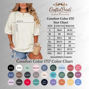 May include: A person wearing a cream-colored Comfort Color 1717 t-shirt, with a size chart and color chart displayed. The size chart shows measurements in inches for sizes S to 4XL. The color chart includes colors like black, white, and red.