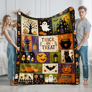 May include: A rectangular throw blanket featuring a grid of Halloween-themed illustrations including a ghost, a haunted house, a black cat in a witch hat, a cauldron, pumpkins, bats, and candy corn. The center text reads TRICK OR TREAT.