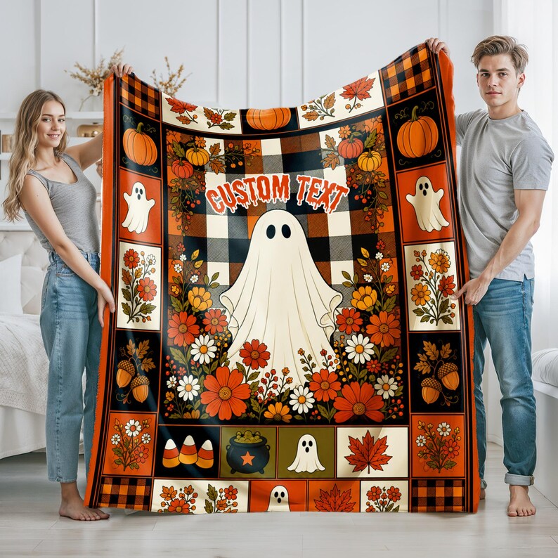 May include: A rectangular throw blanket featuring a central white ghost, the text CUSTOM TEXT, and a black and orange buffalo plaid background. The border includes illustrations of pumpkins, ghosts, autumn flowers, acorns, and a cauldron.