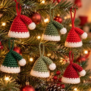 May include: A collection of six crocheted ornaments shaped like miniature hats, featuring red and green yarn bodies with white trim and pom-poms. Each hat includes a matching yarn loop for hanging on a Christmas tree branch.