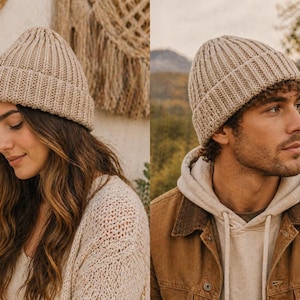 May include: Two people wearing ribbed knit beanies in a neutral beige color. The beanies have a folded brim and a vertical rib pattern. One person is wearing a cream-colored sweater, and the other is wearing a brown jacket over a hoodie.