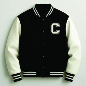 May include: Black varsity jacket with cream-colored sleeves and a white "C" patch. The jacket features a button-up front, a ribbed collar, cuffs, and hem with white stripes. A classic, sporty outerwear piece.