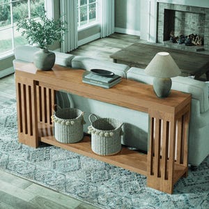 May include: A white ceramic mug with a black handle and the text "But First, Coffee" in a black, handwritten-style font. The mug is on a white surface.