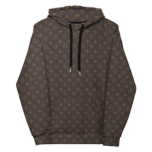 May include: Brown hoodie with a repeating pattern of interlocking shapes and symbols. The hoodie has a drawstring hood, a front pocket, and black drawstrings. The pattern is in a lighter shade of brown against a darker brown background.