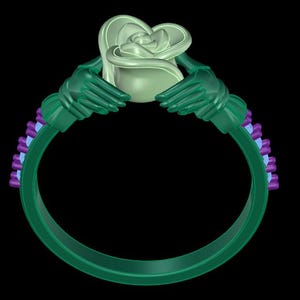 May include: A ring featuring a central pale green rose held by two dark green hands. The band is dark green with a series of small, light blue and purple rectangular accents along the sides, creating a detailed and structured design.