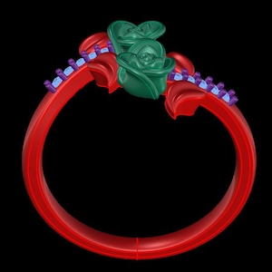 May include: A ring featuring a bright red band adorned with two dark green rose blossoms at the top. The band is accented with red leaf-shaped elements and two rows of small, light blue stones set within purple prongs along the upper sides.