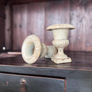 May include: A set of three ceramic mugs with a speckled, matte finish. The mugs are in shades of cream, light gray, and dark gray. Each mug has a simple, minimalist design, perfect for coffee or tea.