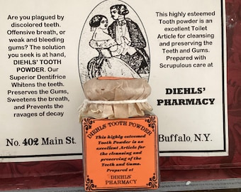 May include: A vintage advertisement for Diehl's Tooth Powder. The advertisement features a small glass jar with a label and a black and white illustration of a couple. The text on the label says "Diehl's Tooth Powder".