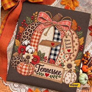 May include: A square wall art piece featuring a large pumpkin illustration with patchwork patterns including leopard print, orange gingham, and black buffalo check. It includes a Tennessee state cutout, a tag reading Home Sweet Home, and the text Tennessee.