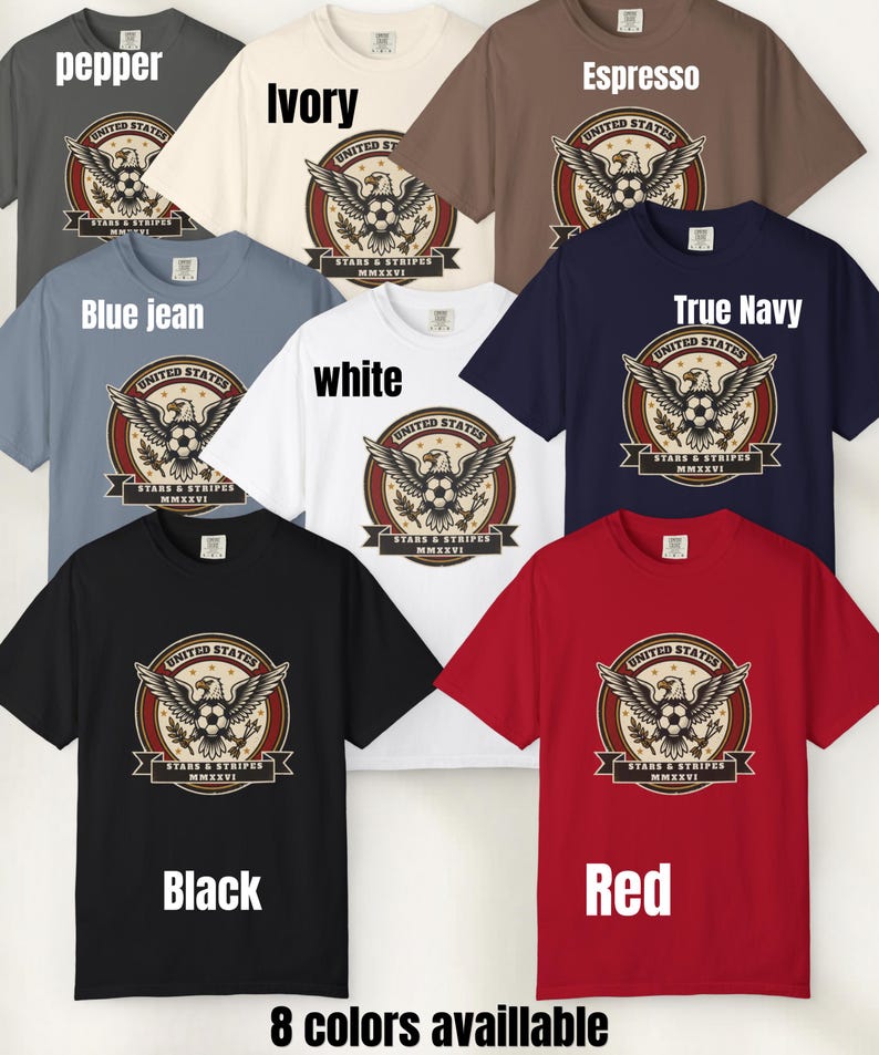 May include: A collection of eight t-shirts in various colors, including pepper, ivory, espresso, blue jean, white, true navy, black, and red. Each shirt features a graphic with an eagle, soccer ball, and text that reads "UNITED STATES STARS & STRIPES MMXXVI".
