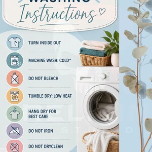 May include: A laundry care guide with the title "Washing Instructions" in a decorative font. The guide includes icons and text instructions such as "Turn Inside Out", "Machine Wash: Cold", and "Do Not Bleach". A washing machine and laundry basket are also visible.