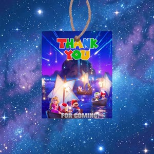 May include: A white ceramic mug with a black handle and the text "But First, Coffee" in a bold, black font. The mug is set against a blurred background, suggesting a cozy setting.