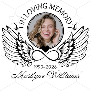 May include: A memorial design featuring a smiling woman's photo within a circular frame, surrounded by the words "IN LOVING MEMORY." Wings, an infinity symbol, and a heart are included, along with the years 1990-2026 and the name "Marilyne Williams."