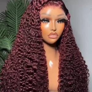 May include: A deep burgundy lace front wig with tight, defined curls worn on a mannequin head. The hair features a side part and a natural-looking hairline. The text "Best in Curly Hairs" is visible at the top of the image in white font.
