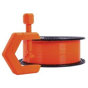May include: An orange Prusa clamp is in front of a spool of orange filament. The clamp has a screw mechanism. The filament is on a black spool. The clamp and filament are for 3D printing.