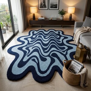 May include: A large, abstract rug with a wavy design in shades of navy and light blue. The rug has a unique, organic shape, adding a modern touch to the living room. The rug is made of a soft, plush material.
