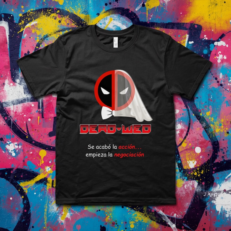 May include: Black t-shirt featuring a graphic design that combines the Deadpool logo with a ghost-like figure. The text "DEAD-WED" is displayed in red and white, with Spanish text below.