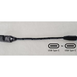 May include: A black cable with a connector labeled PDI 7800 on one end and a blue USB Type-C connector on the other. A graphic below the cable shows two USB Type-C symbols connected by the word to, indicating a USB Type-C to USB Type-C connection.