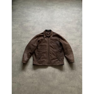 May include: A brown leather jacket with a collared neckline and a full-length zip. The jacket features two front pockets and a classic, vintage style. The leather has a distressed appearance, adding to its rugged aesthetic.